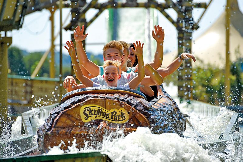Abenteuer auf der Wildwasserbahn im Skyline Park Menschen auf einer Wildwasserbahn im Skyline Park mit erhobenen Händen und sichtbarer Freude.